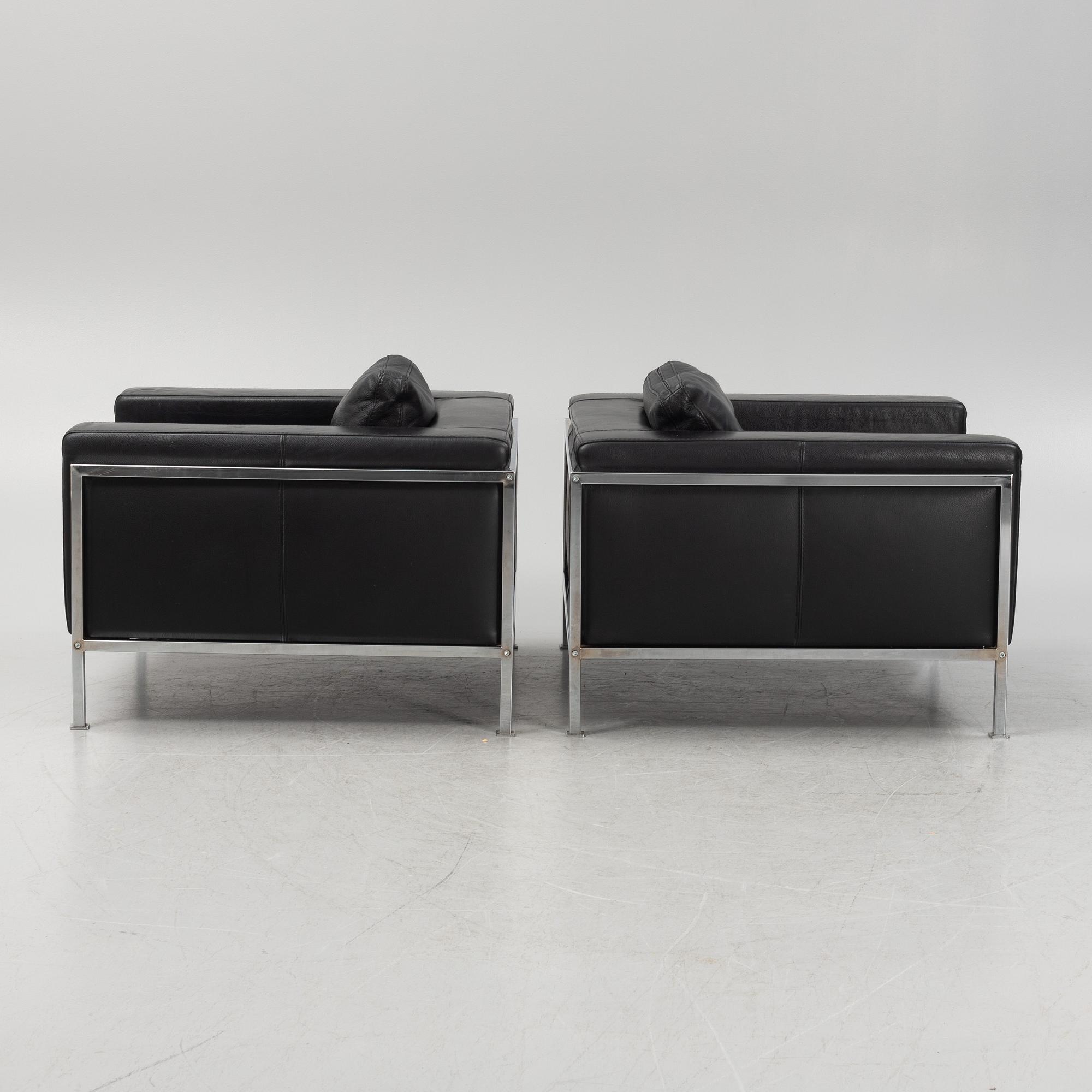 A pair of leather upholstered lounge chairs,