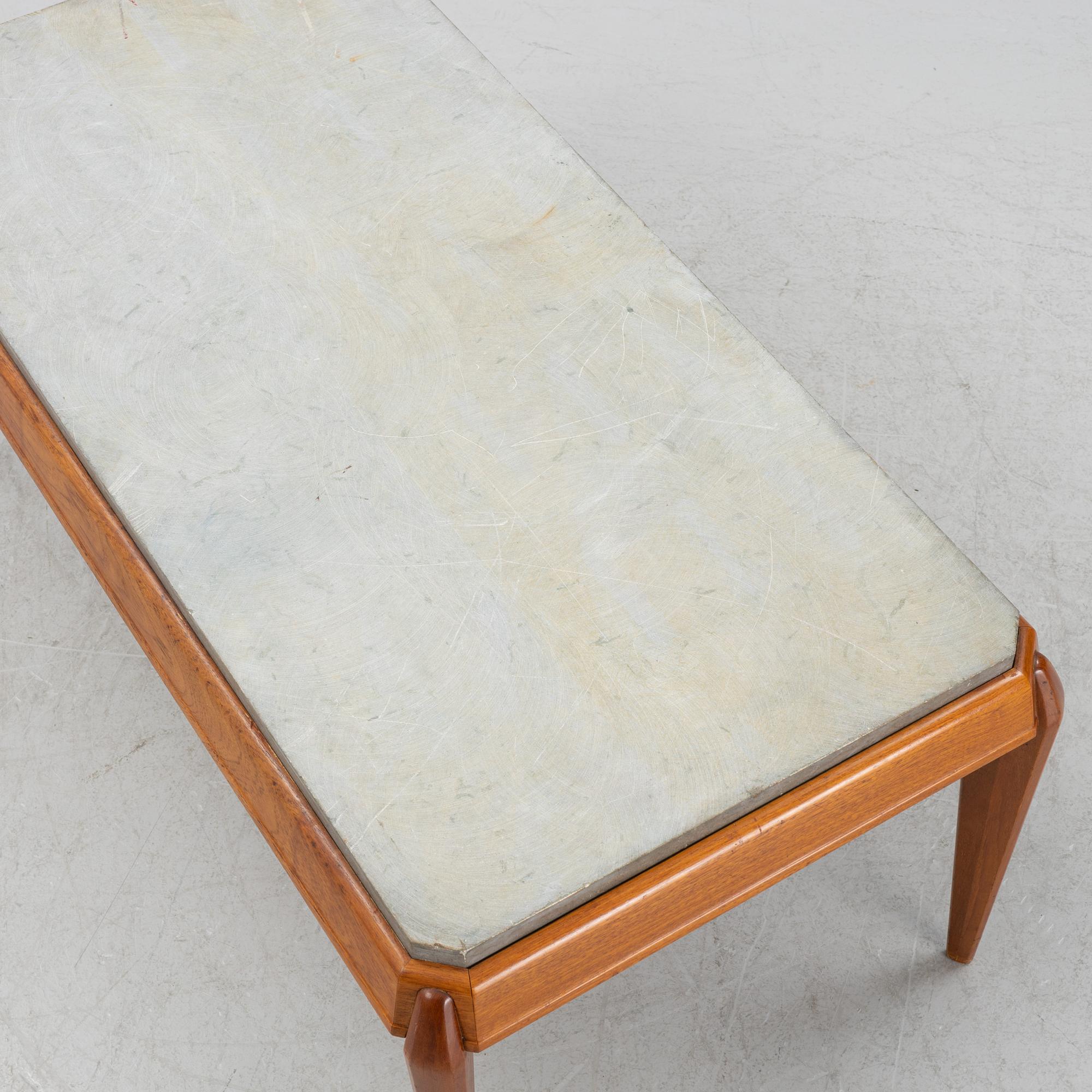 A mid 20th Century coffee table with a stone top.