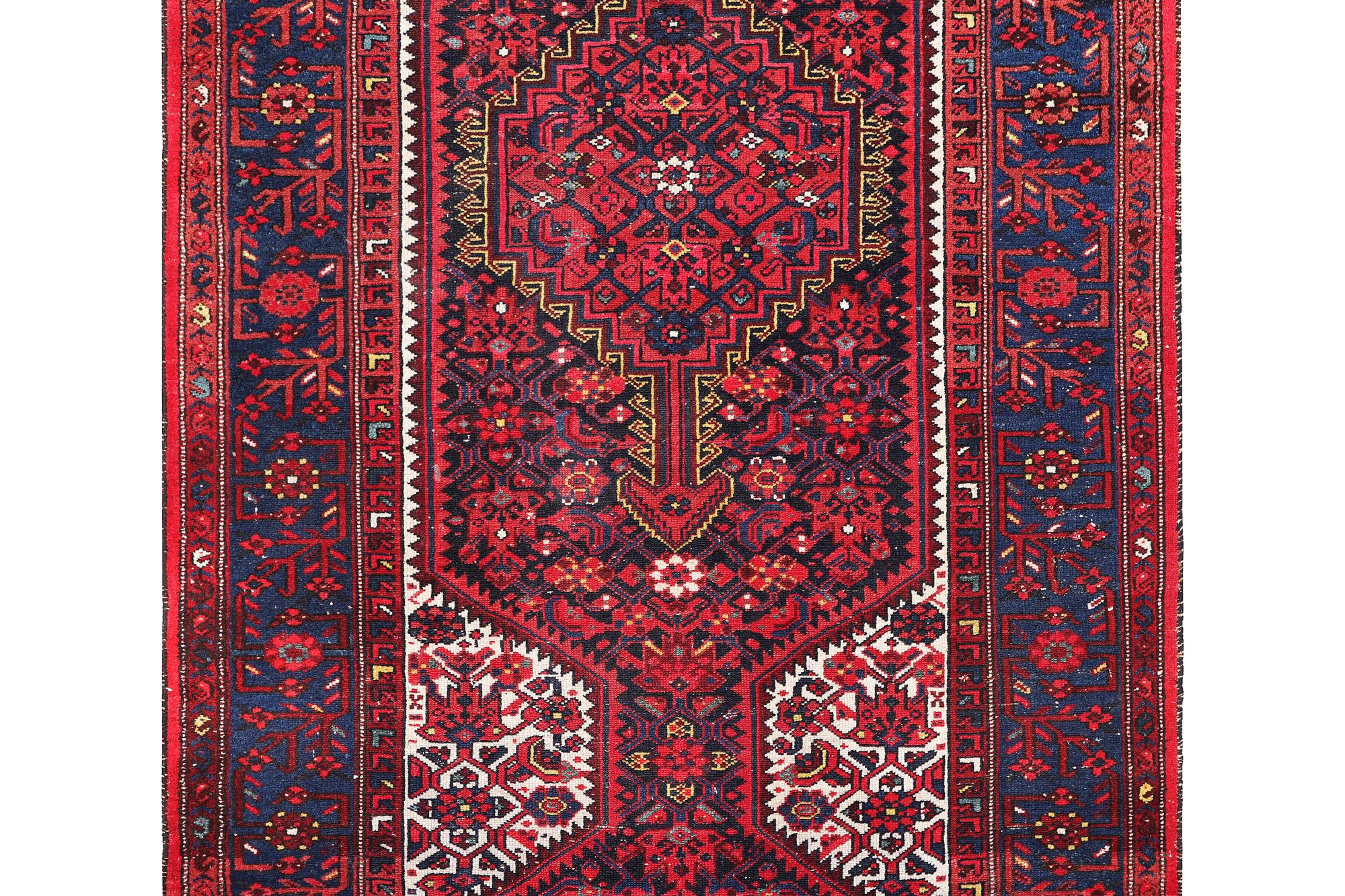 A Hosseinabad carpet, c. 391 x 135 cm.