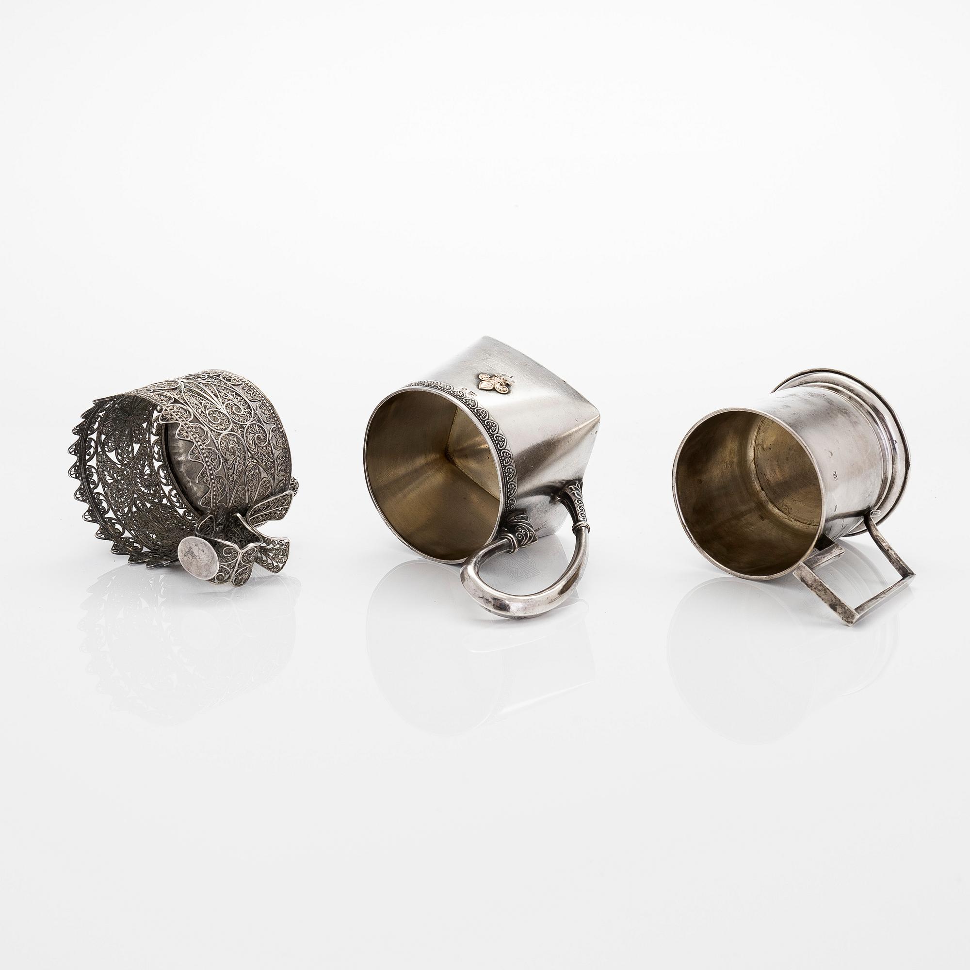 Three silver tea glass holders and four spoons, silver Kostroma and Moscow, late 19th and early 20th centuries.