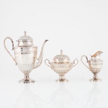 A Swedish Silver Coffee Pot, Creamer and Sugar Bowl, mark of CG Hallberg, Stockholm 1897.