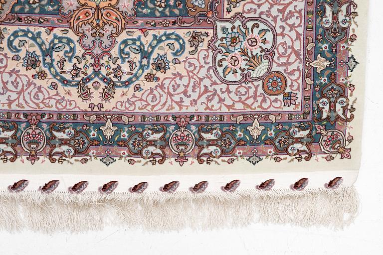 A Tabriz carpet, 210 x 195 cm. signed.