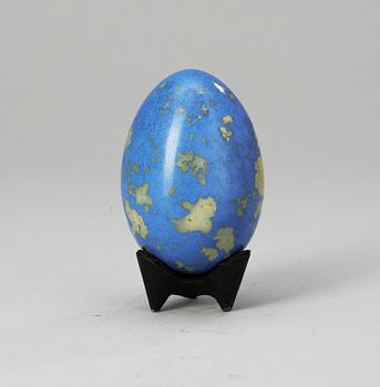 A Hans Hedberg faience egg on an iron base, Biot, France.