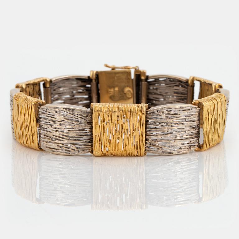 An 18K gold and white gold bracelet.
