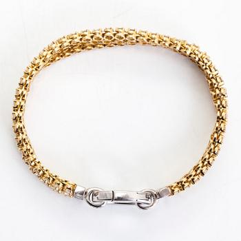 An 18K gold 3-strand tennisbracelet, set with brilliant-cut diamonds totalling approximately 10.54 ct.