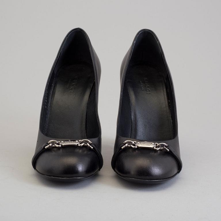 A pair of black pumps by Gucci.