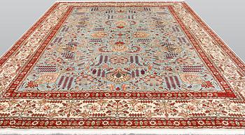 A Tabriz carpet, signed, approx. 390 x 297 cm.