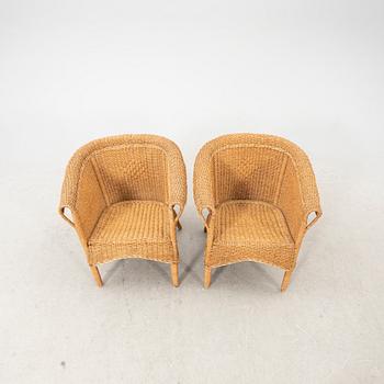 A pair of early 1900s wicker chairs.