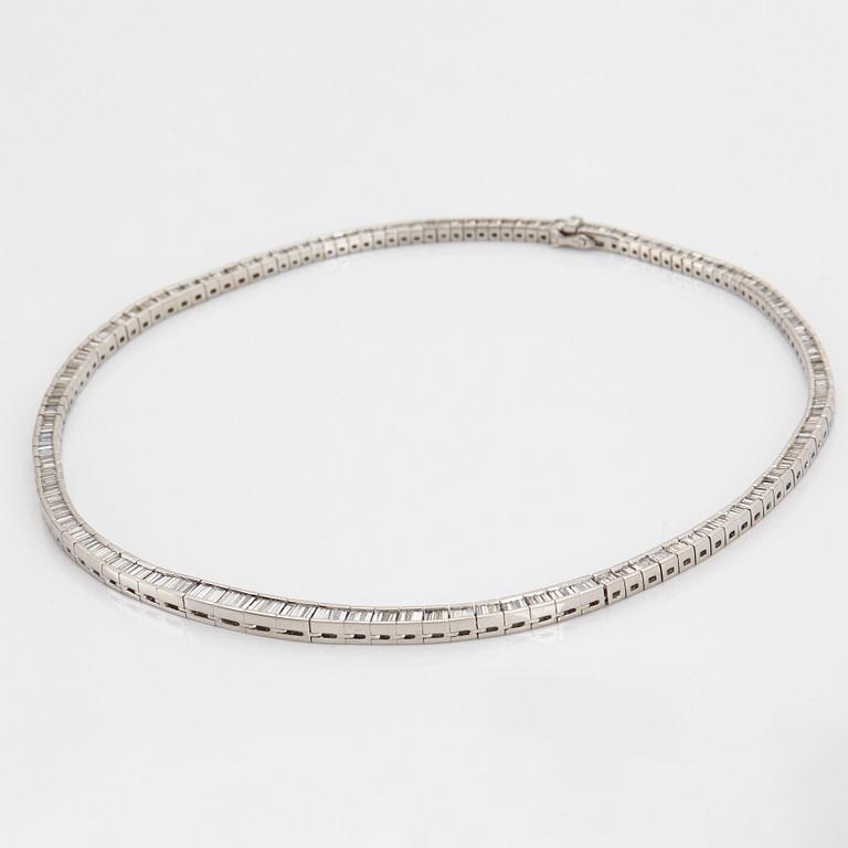 A platinum necklace set with tapered baguette-cut diamonds.