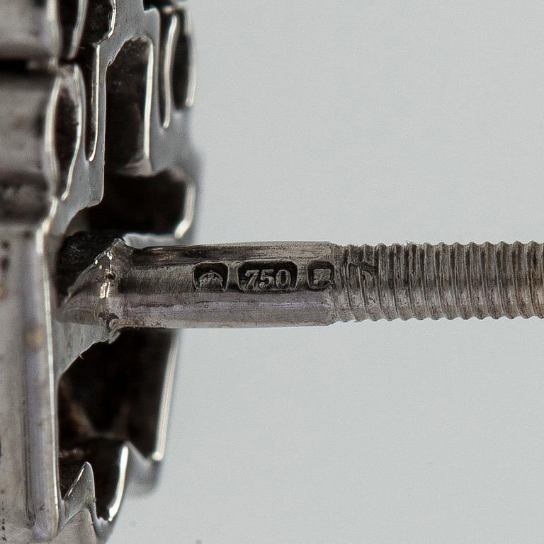 A pair of 18K white gold earrings set with baguette-cut and brilliant-cut diamonds.