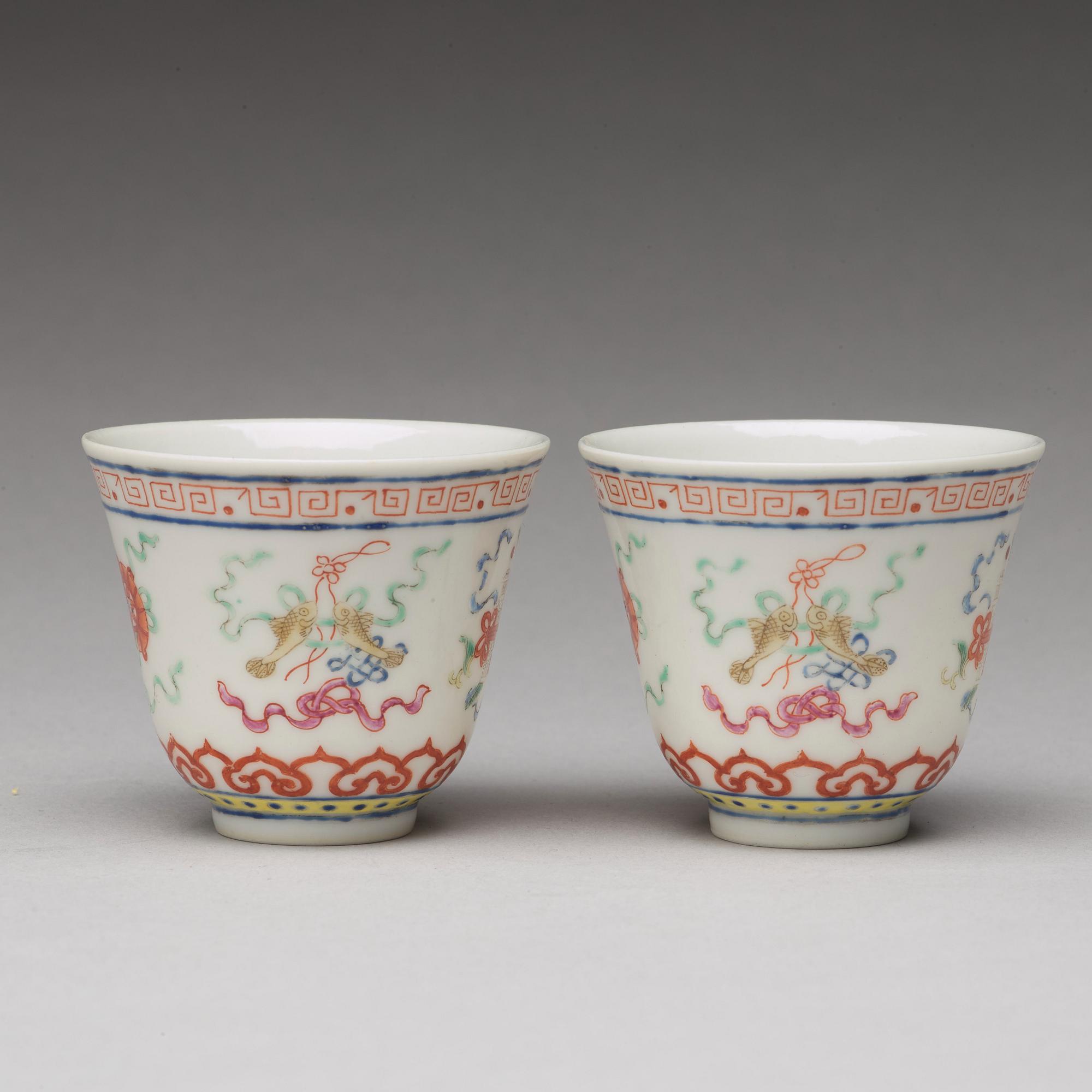 A pair of Chinese famille rose ba jixiang wine cups, Republic, with Guangxu six character mark.