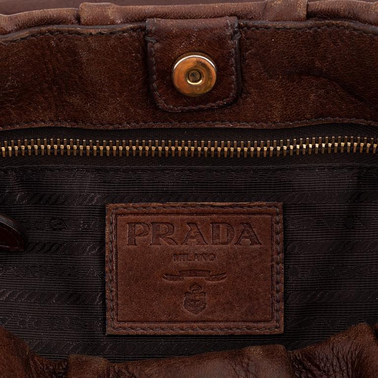 Prada, a brown leather bag.