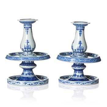 1357. A pair of blue and white pricket candle sticks, with a poem, Qing dynasty with a Qianlong mark and of the period.