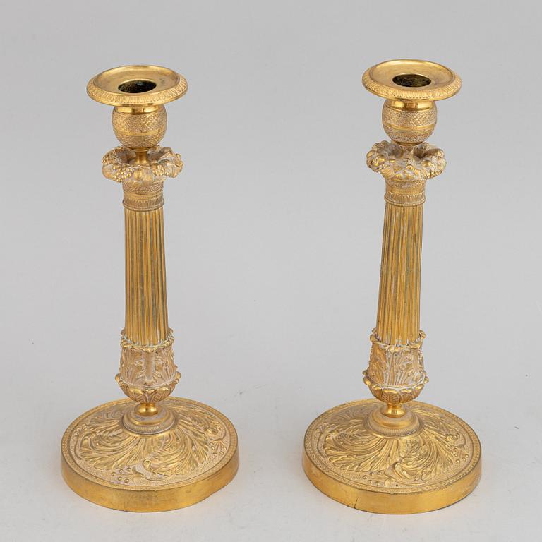 A circa 1900 empire style brass candlesticks.