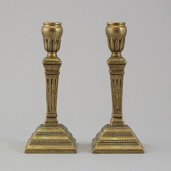 A pair of late 18th century bronze candlesticks.