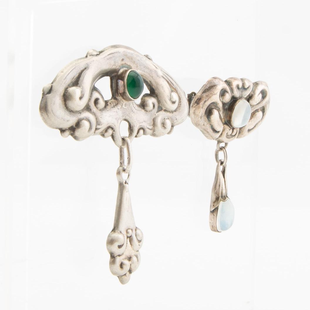 Brooches, 2 pieces, Art Nouveau, early 20th century, pewter, moonstone, and green stone.