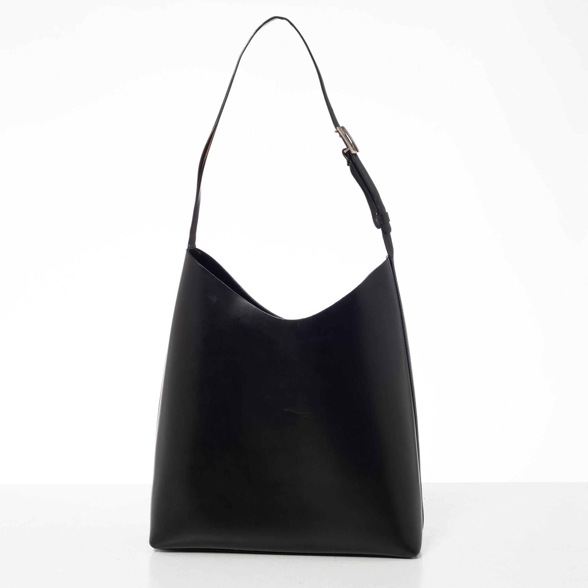 Gucci, A black leather bag.