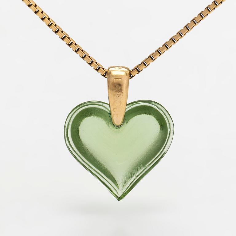 A Lalique heart pendant with an 18K gold chain.