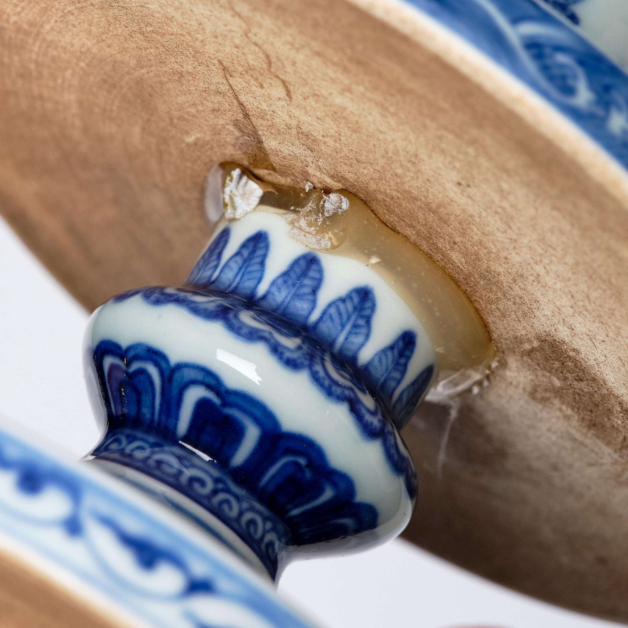 A pair of blue and white pricket candle sticks, with a poem, Qing dynasty with a Qianlong mark and of the period.