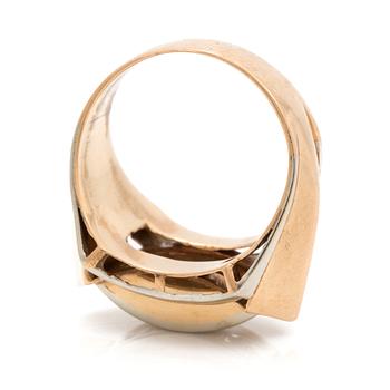 A ring set with three faceted, white stones.