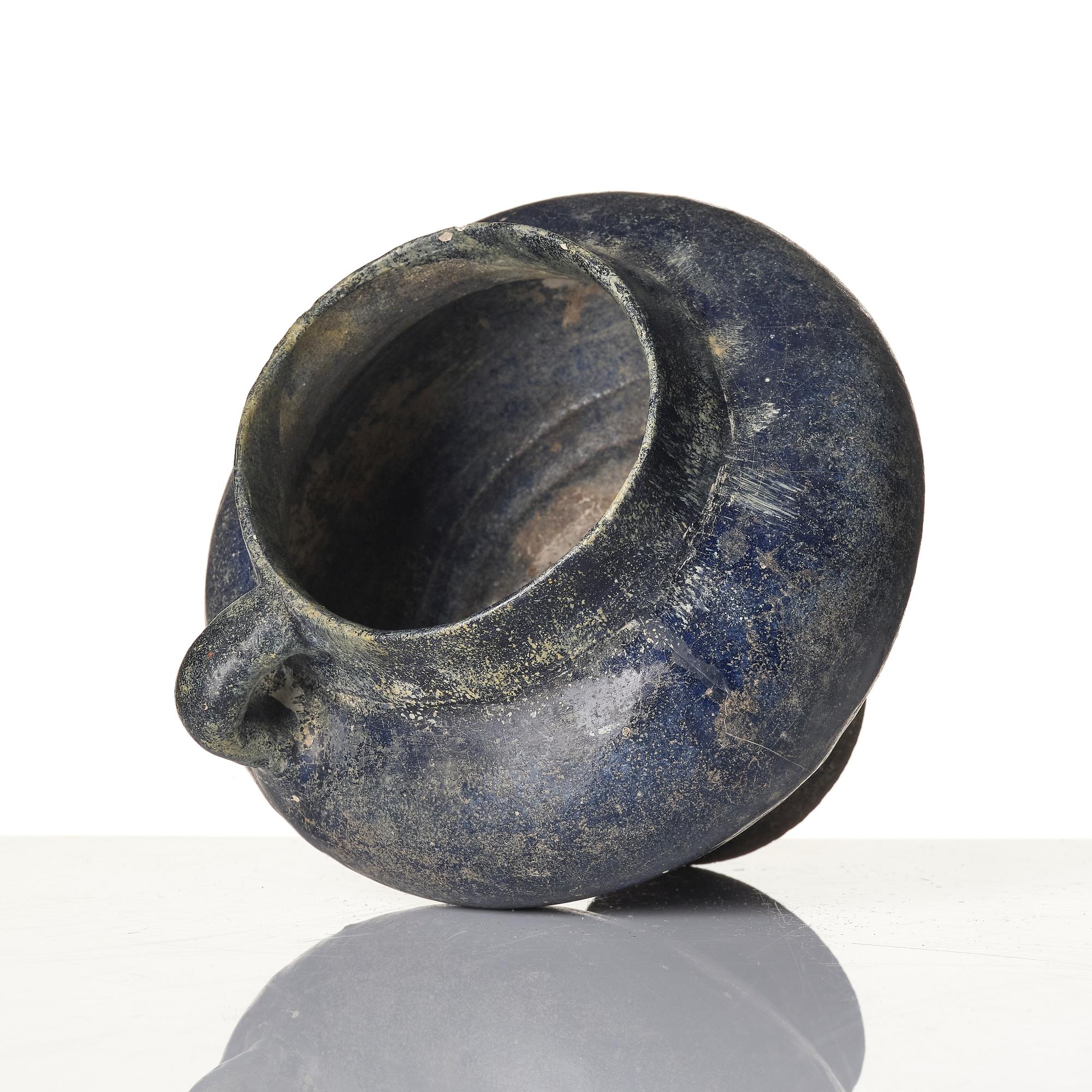 A blue-glazed Nishapur pottery Jug, Persia, 13th century.