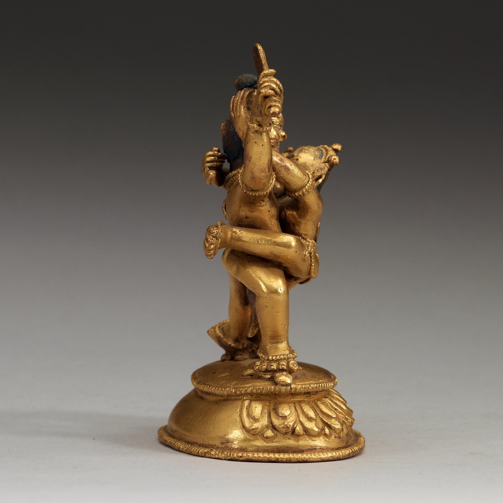 A Tibetan gilt bronze figure of Yab Yum, presumably circa 1900.