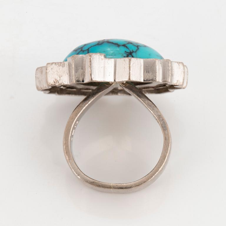 A Grima ring in 14K white gold set with a turquoise and round brilliant-cut diamonds.