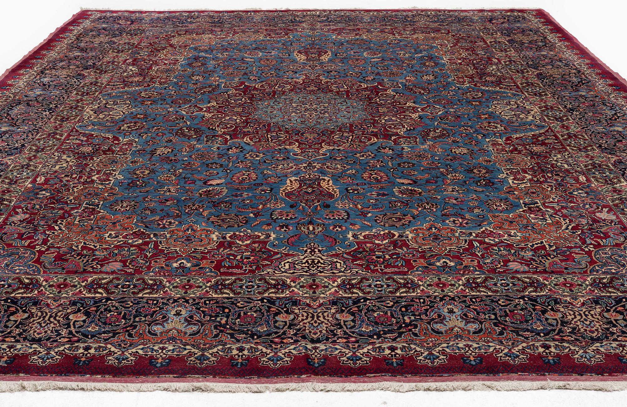 A Mashad carpet, signed Saber, c. 468 x 348 cm.