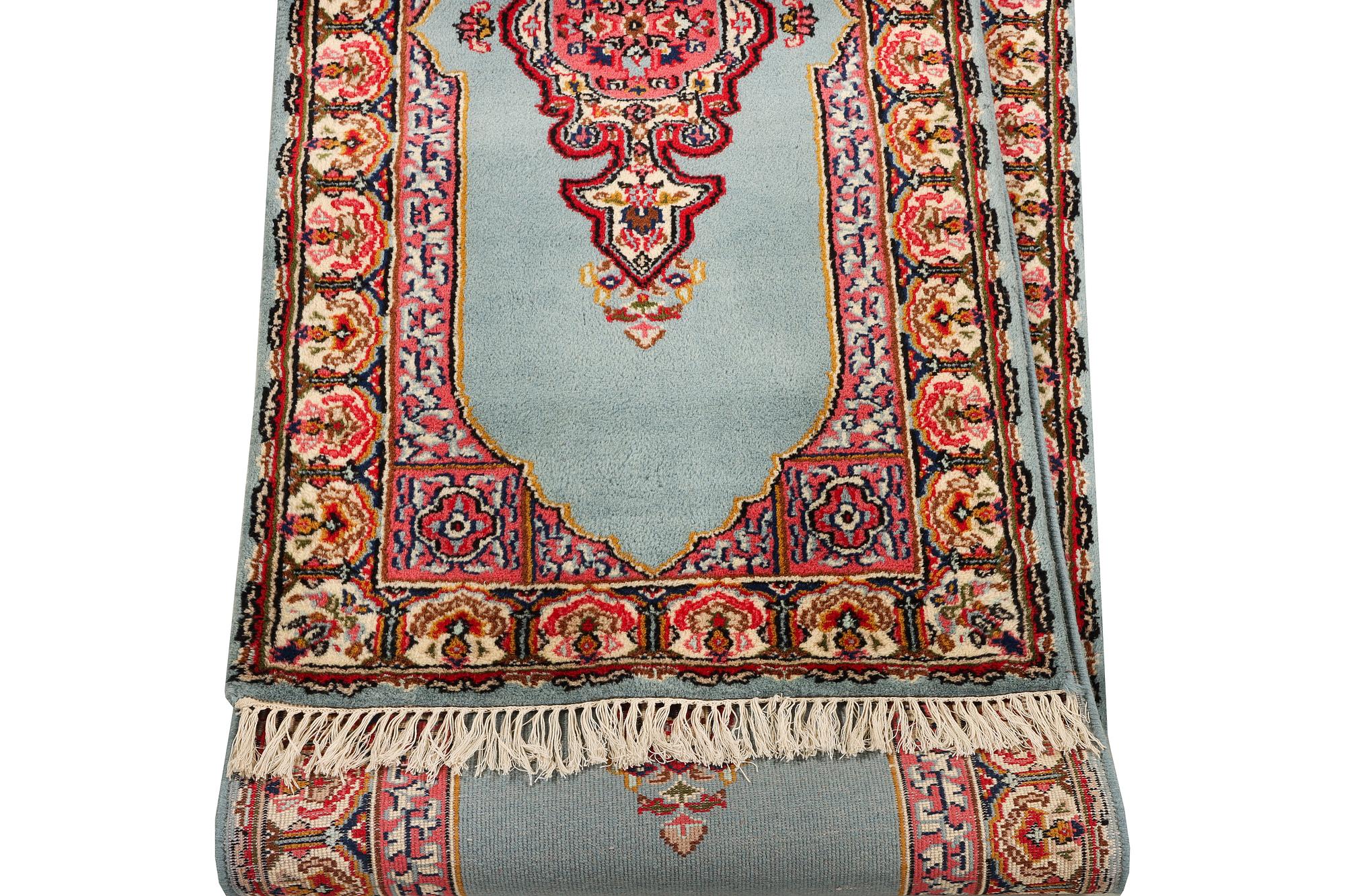 An oriental runner, c. 550 x 74 cm.