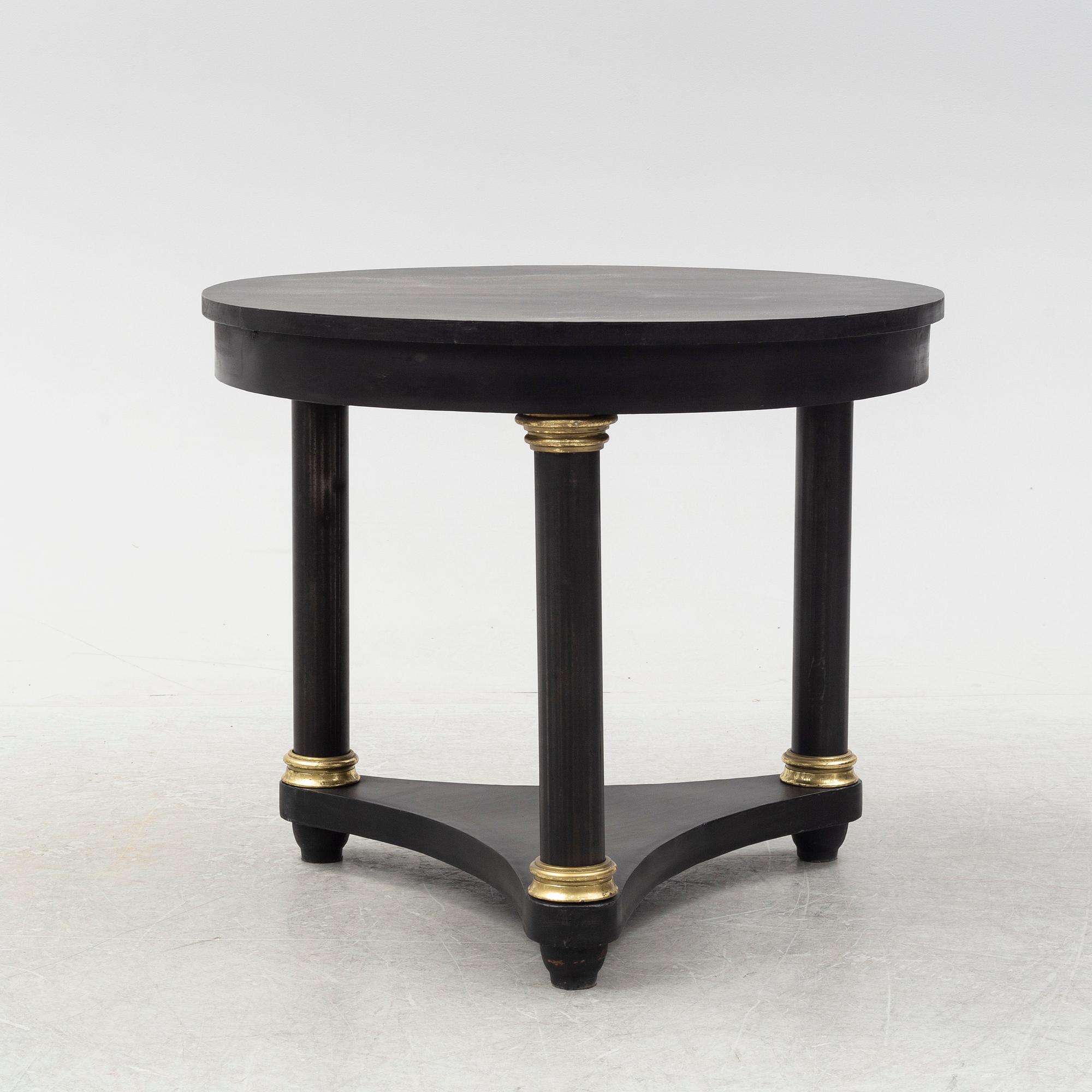 A contemporary empire style sheet metal center table.