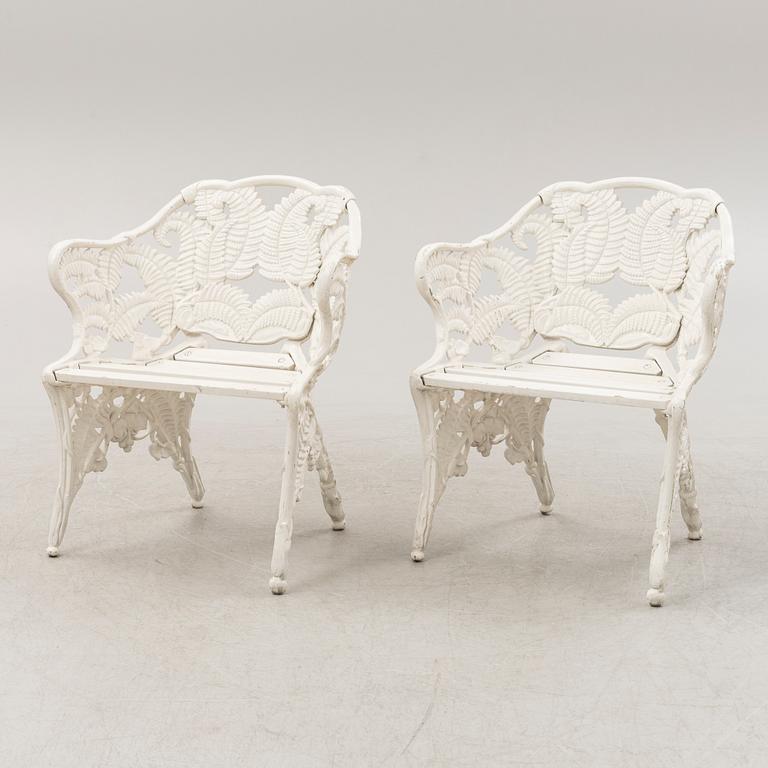 A painted pair of cast aluminum garden armchairs and a table, second part of the 20th Century.