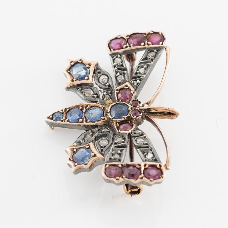 Brooch, in the form of a butterfly, set with sapphires and rubies and rose-cut diamonds.