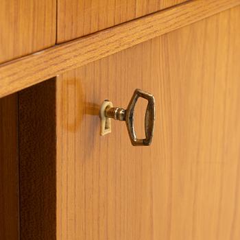 An elmwood-veneered bookcase, Nilsson & Johansson Möbelfabrik, Björnum, mid 20th century.