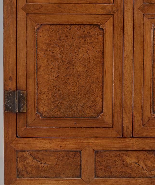 A huanghuali veneered, huamu and mixed wood cabinet, 19th century, Qing dynasty, 19th Century.