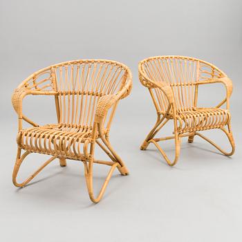 A pair of rattan arm chairs from the latter half of the 20th Century.