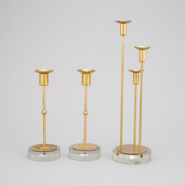Gunnar Ander, a set of three brass and glass candlesticks from Ystad Metall.