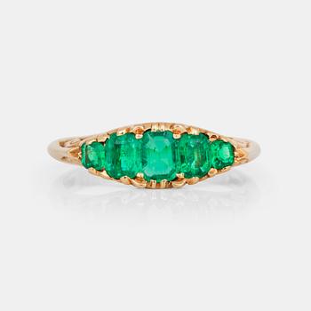 A ring with five step-cut emeralds.