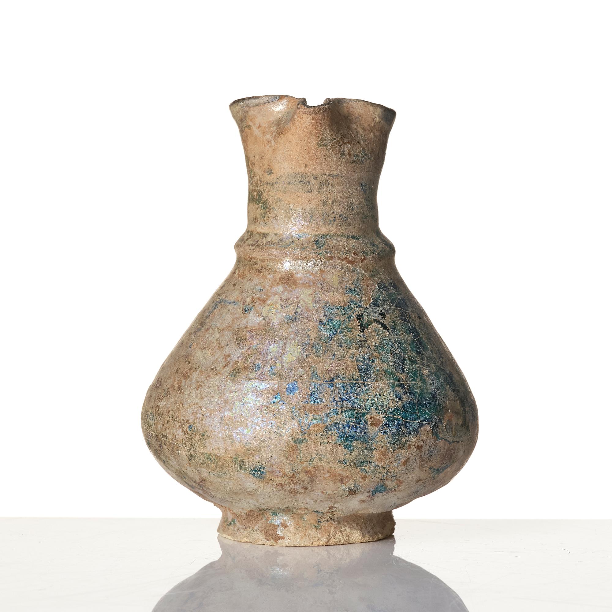 A turquoise-glazed Keshan jug, Persian, 13th century.