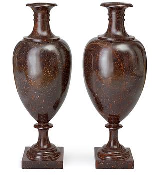 560. A near pair of Swedish Empire circa 1830 large porphyry urns.