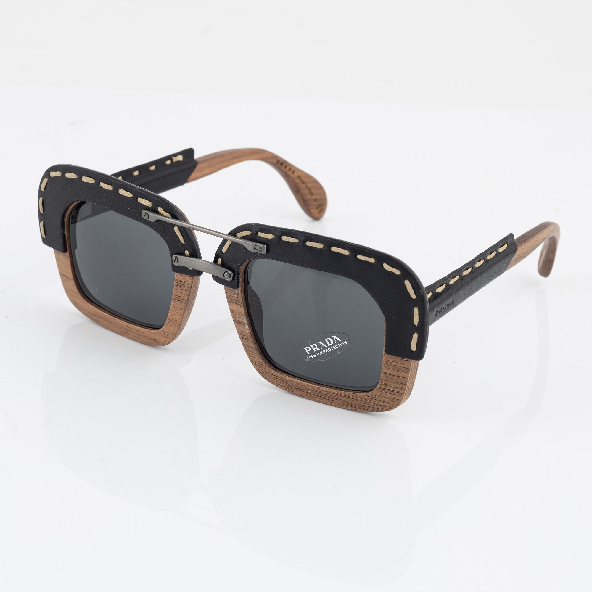 Prada a pair of wood and leather sunglasses. Bukowskis