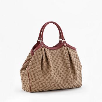 GUCCI, a monogram canvas and red leather tote bag, "Sukey".