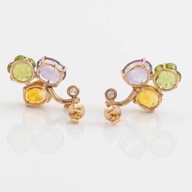 Earrings with yellow sapphires, cut flower-shaped peridot, amethyst, and brilliant-cut diamonds.