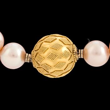 A pearl necklace with an 18K gold clasp by Gaudy according to information given.