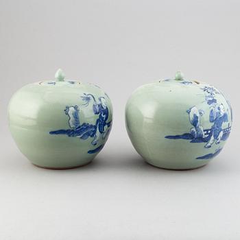 A pair of Chinese celadon glazed and blue and white jars with covers, 20th century.