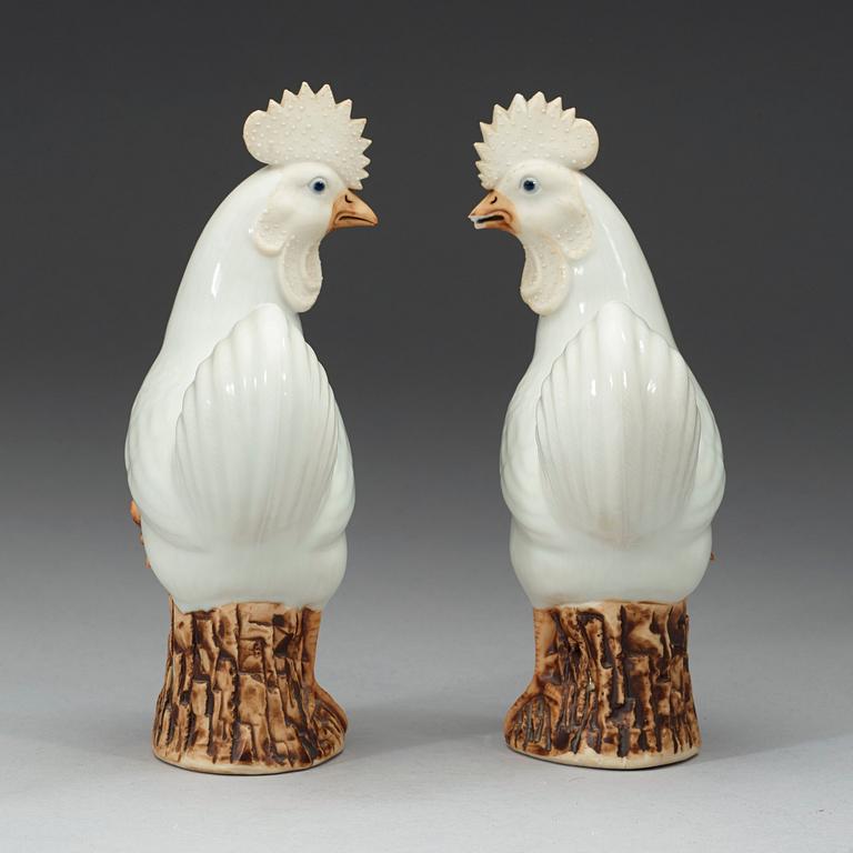 A pair of white and brown glazed figures of roosters, late Qing dynasty,