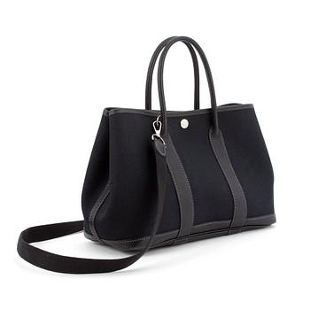 HERMÈS, a black canvas and leather bag, "Garden Party".