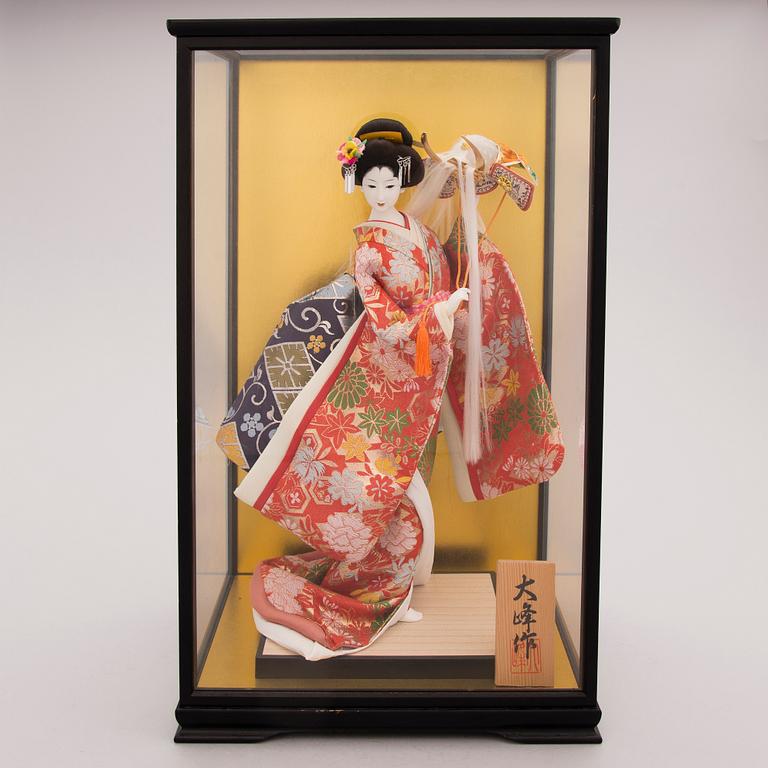 A latter half of the 20th century Japanese doll in showcase.