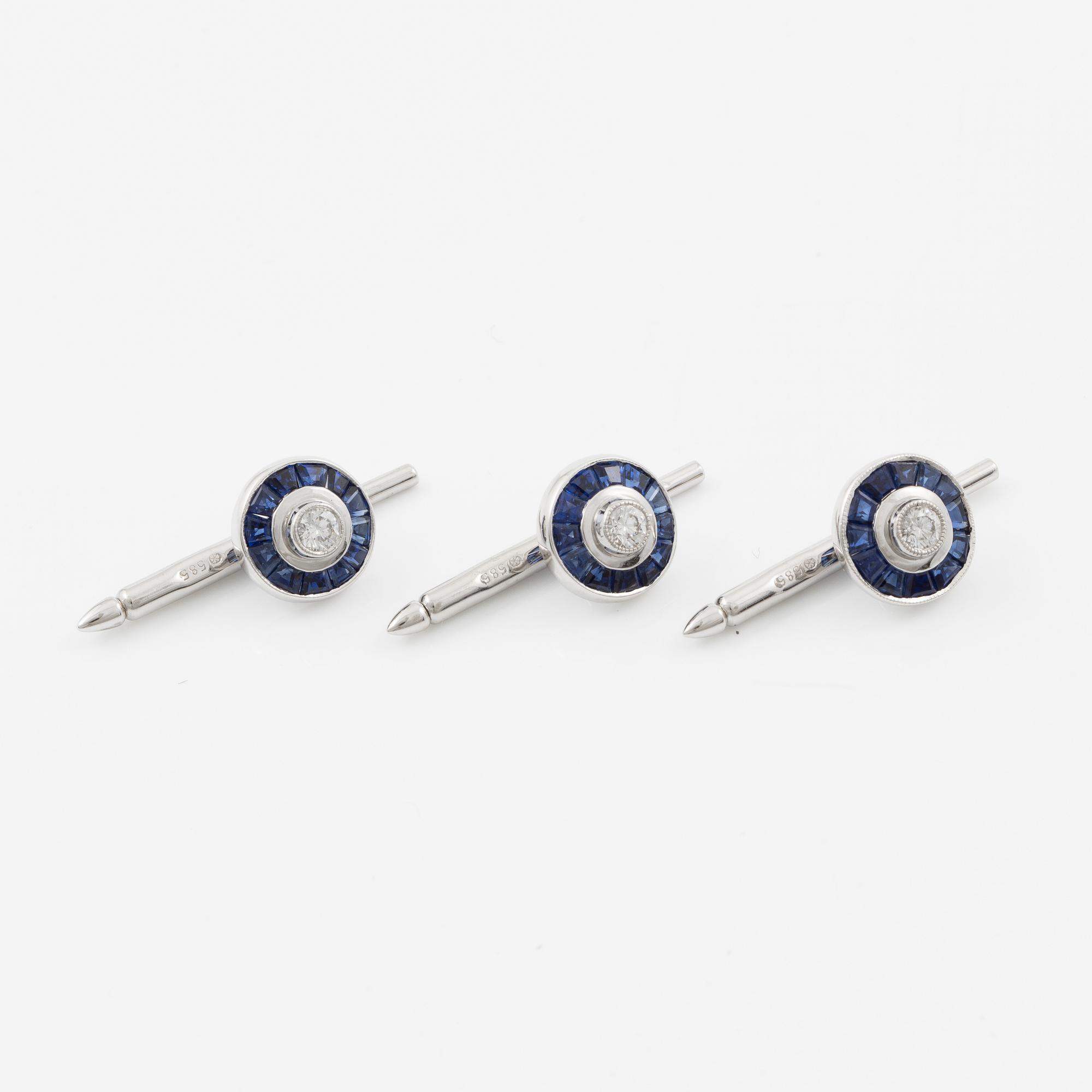 Three shirt buttons in 18K and 14K white gold set with faceted sapphires and round brilliant-cut diamonds.