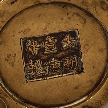 A gilt copper alloy tripod censer, Qing dynasty, presumably 18th Century with Xuandes six character mark.