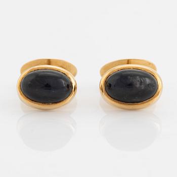 18K gold and cabochon cut blue stone cufflinks.